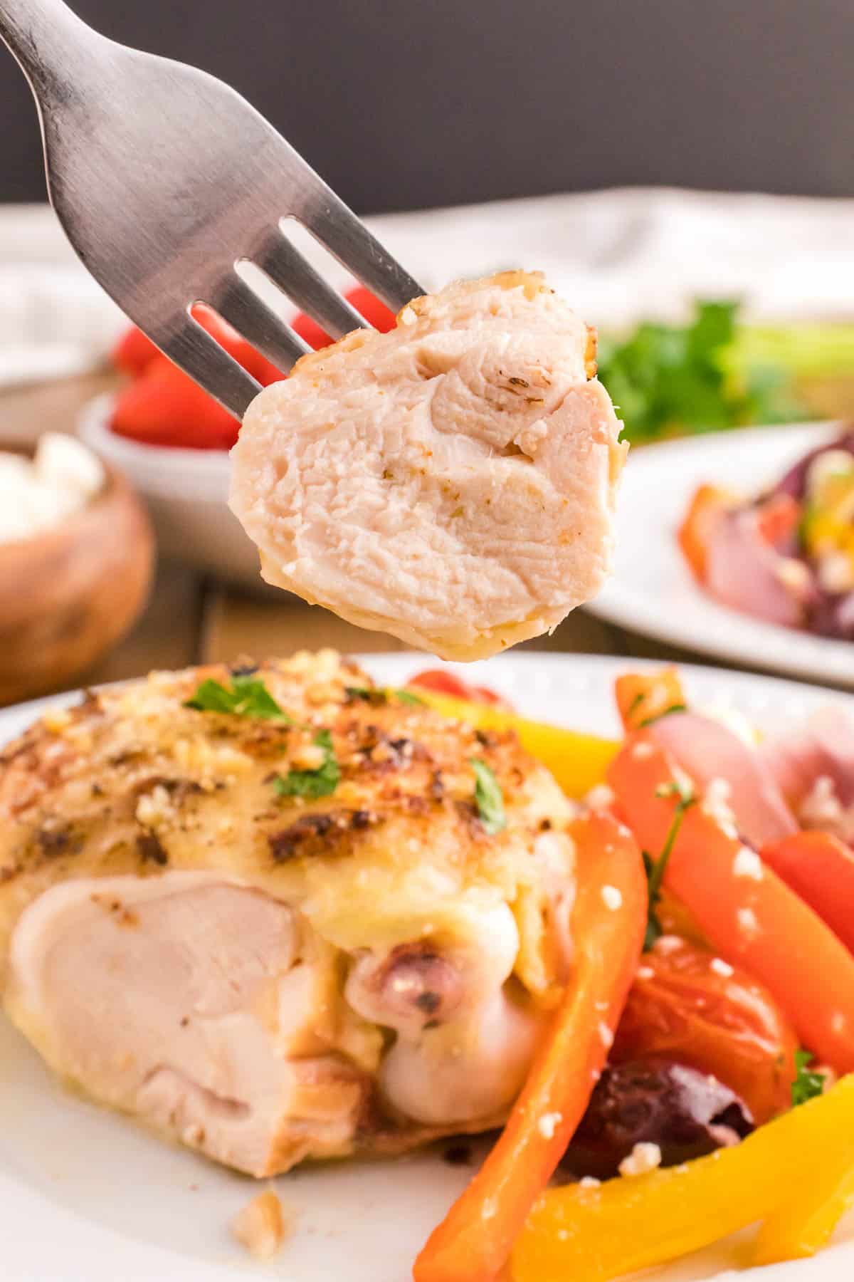 sliced greek marinaded chicken thigh being picked up by a fork