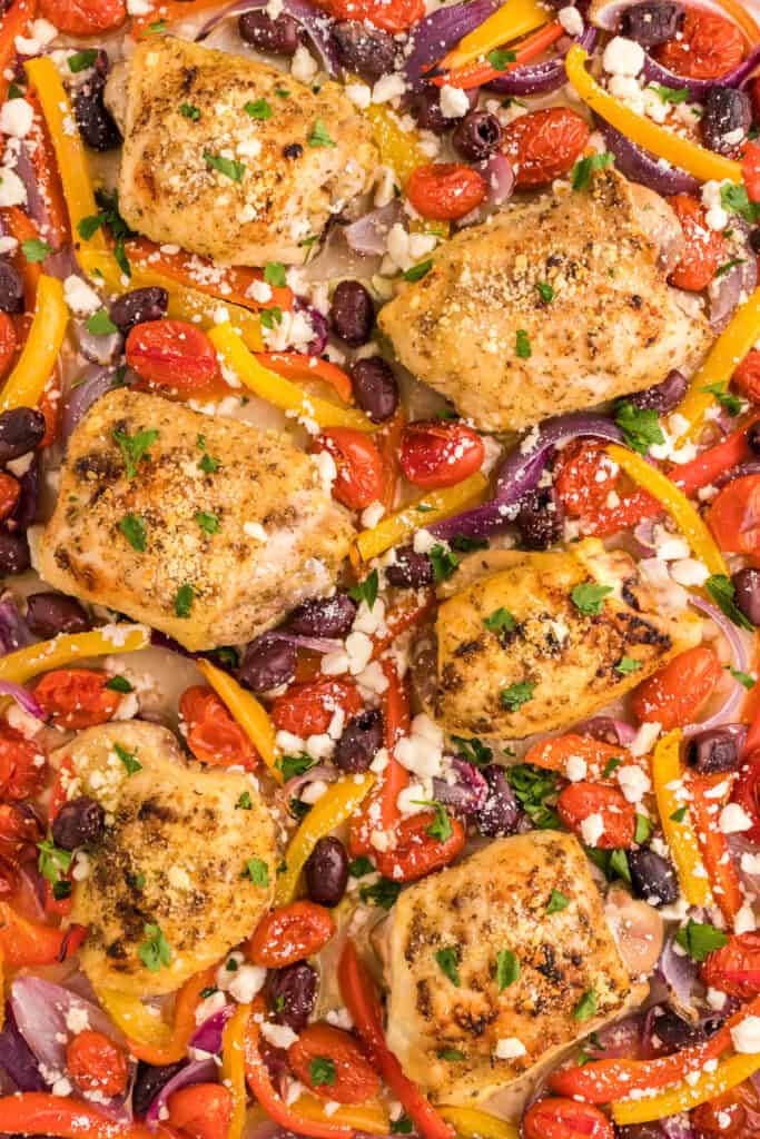 easy greek chicken sheet pan dinner recipe fresh out of the oven with feta cheese and parsley
