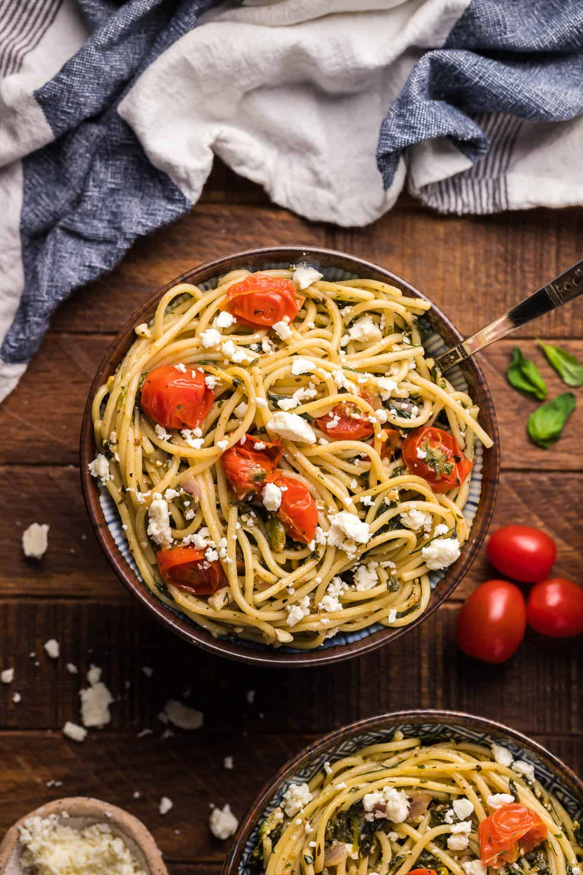 bowl of spaghetti with herbs and cherry tomatoes