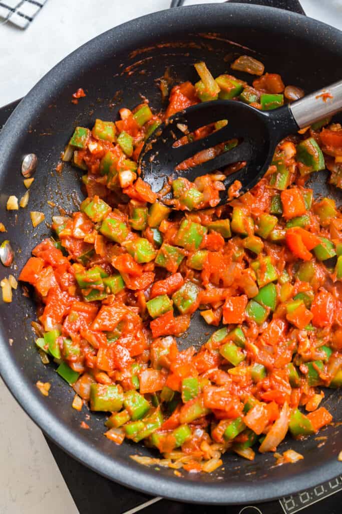 tomato paste with garlic, onions, and bell peppers