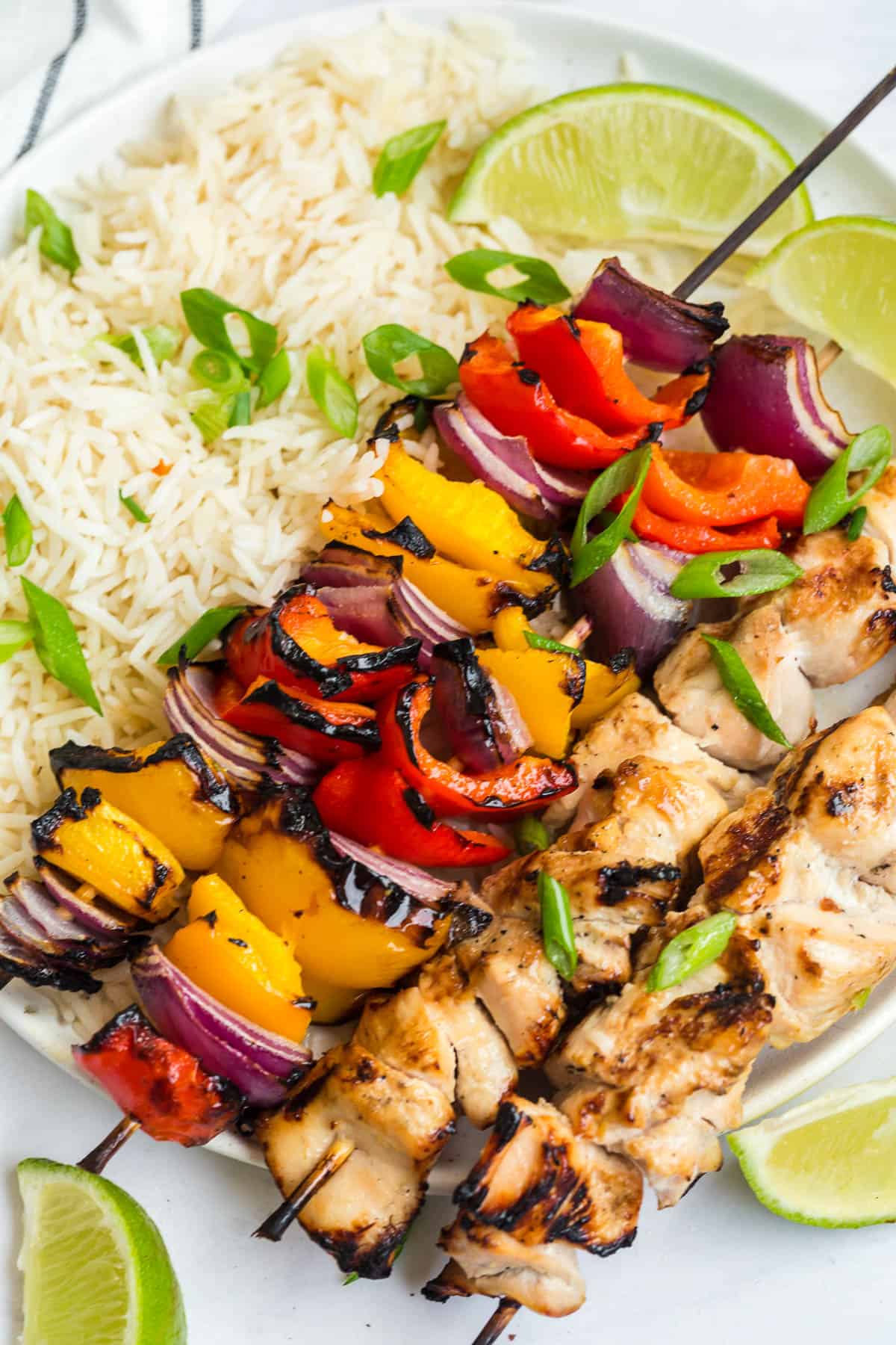 coconut lime chicken skewers with rice and green onions