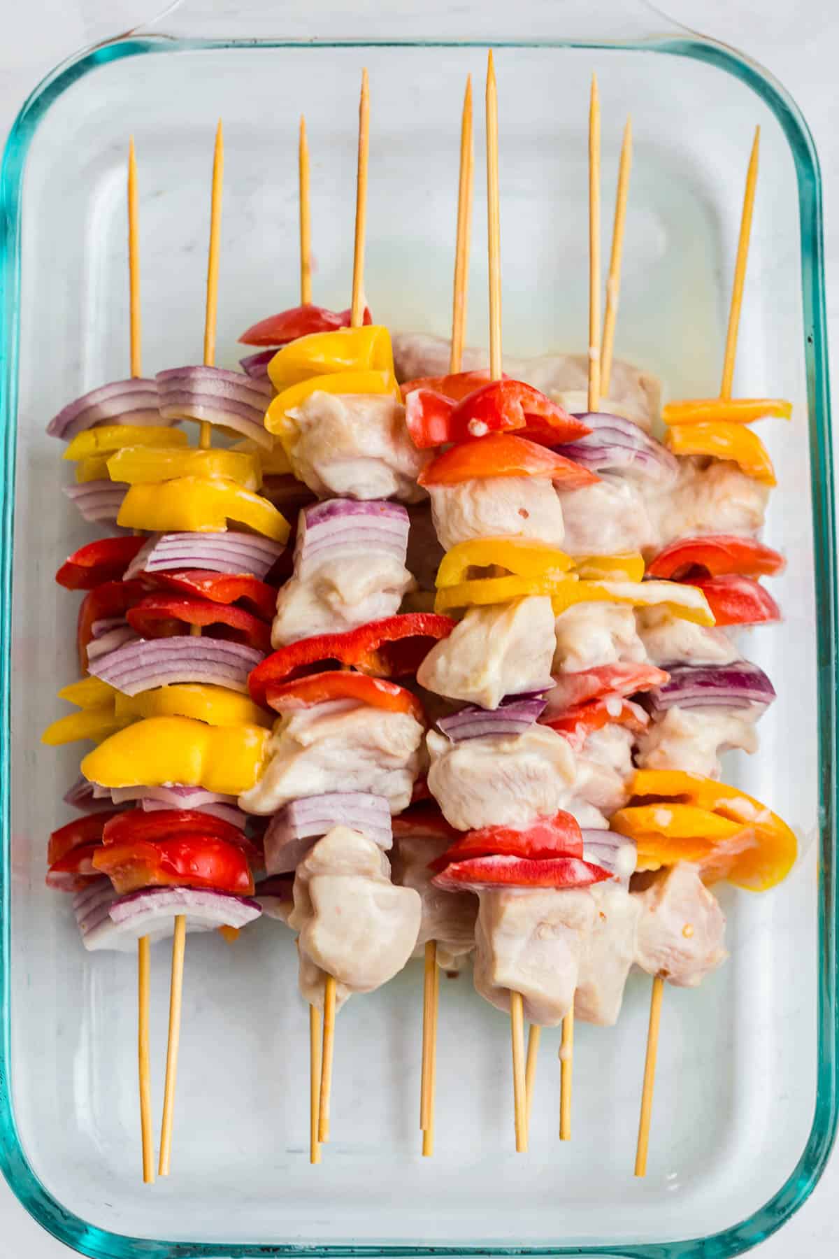 chicken skewers with red pepper, yellow pepper, and red onion