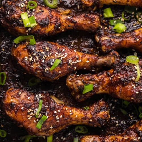 close up of baked drumsticks with a sticky sesame sauce baked on