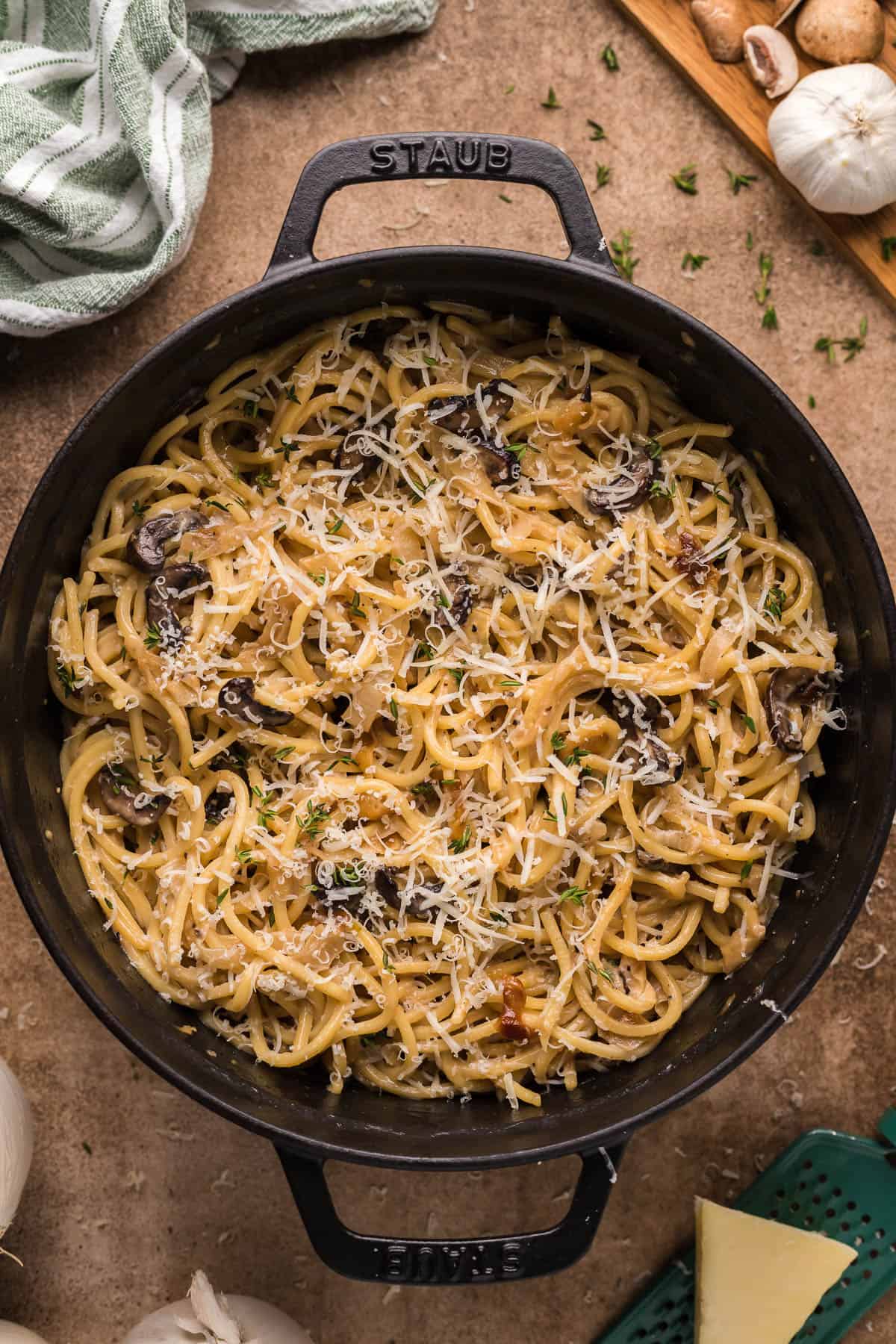 tiktok french onion pasta in a black dutch oven topped with parsley and shredded parmesan