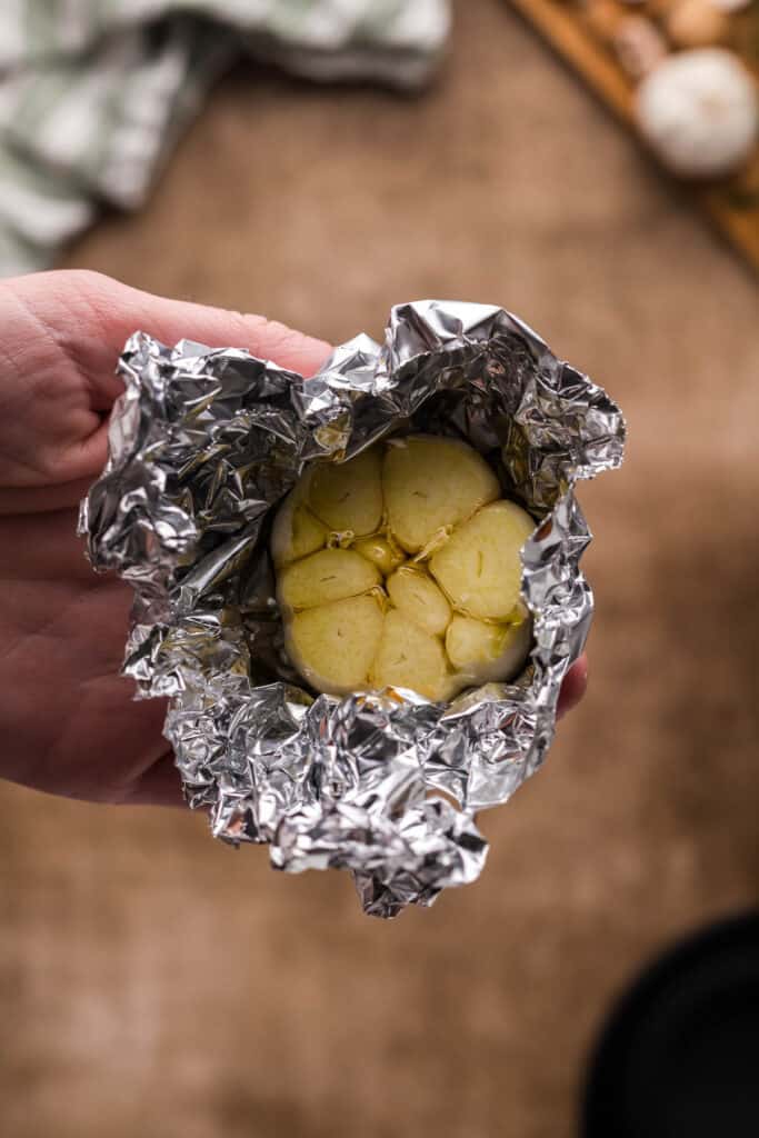 garlic head wrapped in foil with olive oil