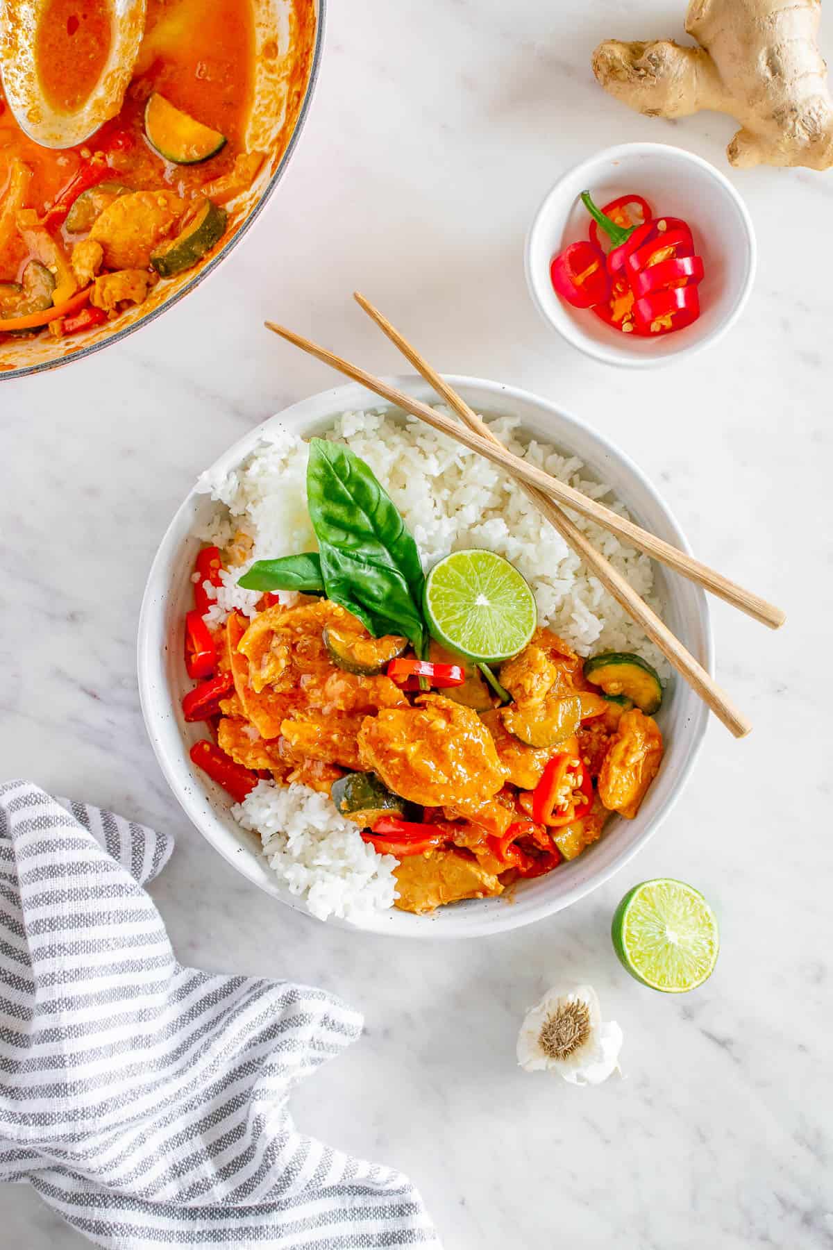 flat lay bowl with jasmine rice topped with a red thai curry chicken 