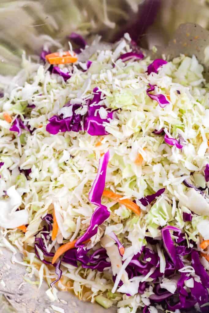 adding bagged cabbage to slaw