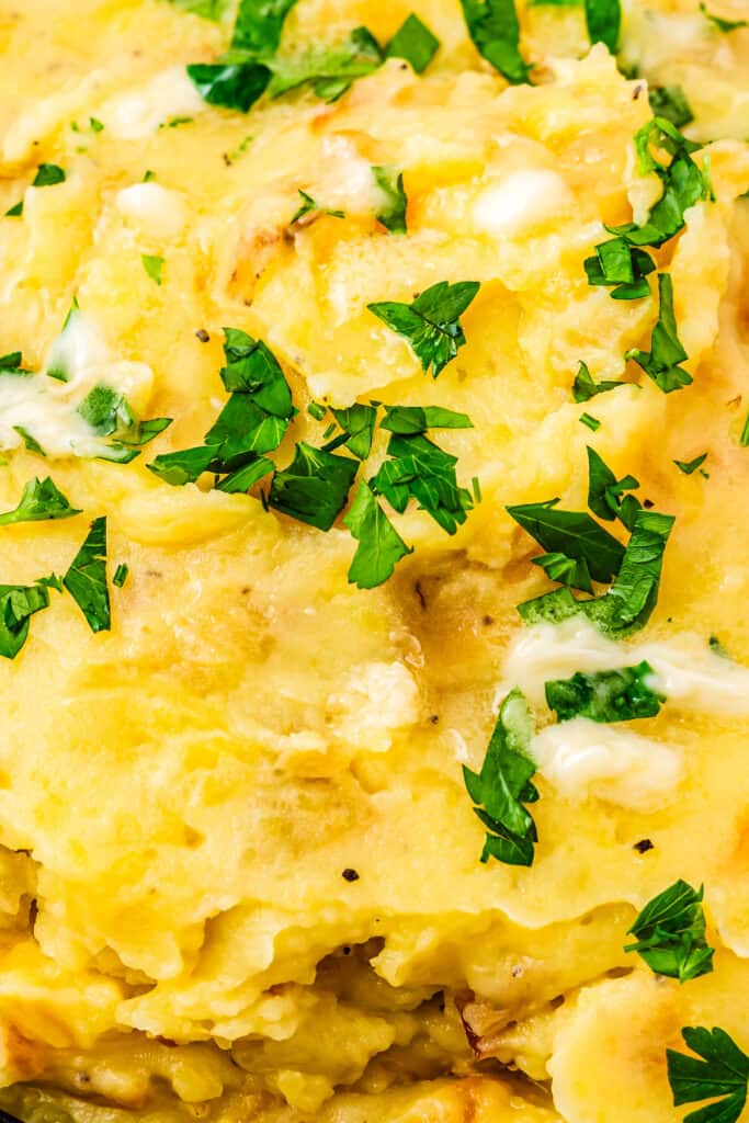 topping mashed potatoes with caramelized onions, parsley, and extra butter