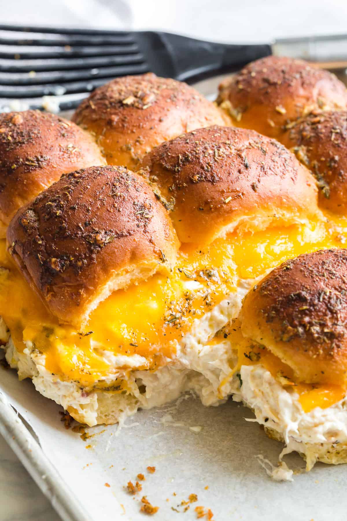 pull apart sandwiches with melted cheddar cheese and a butter herb topping