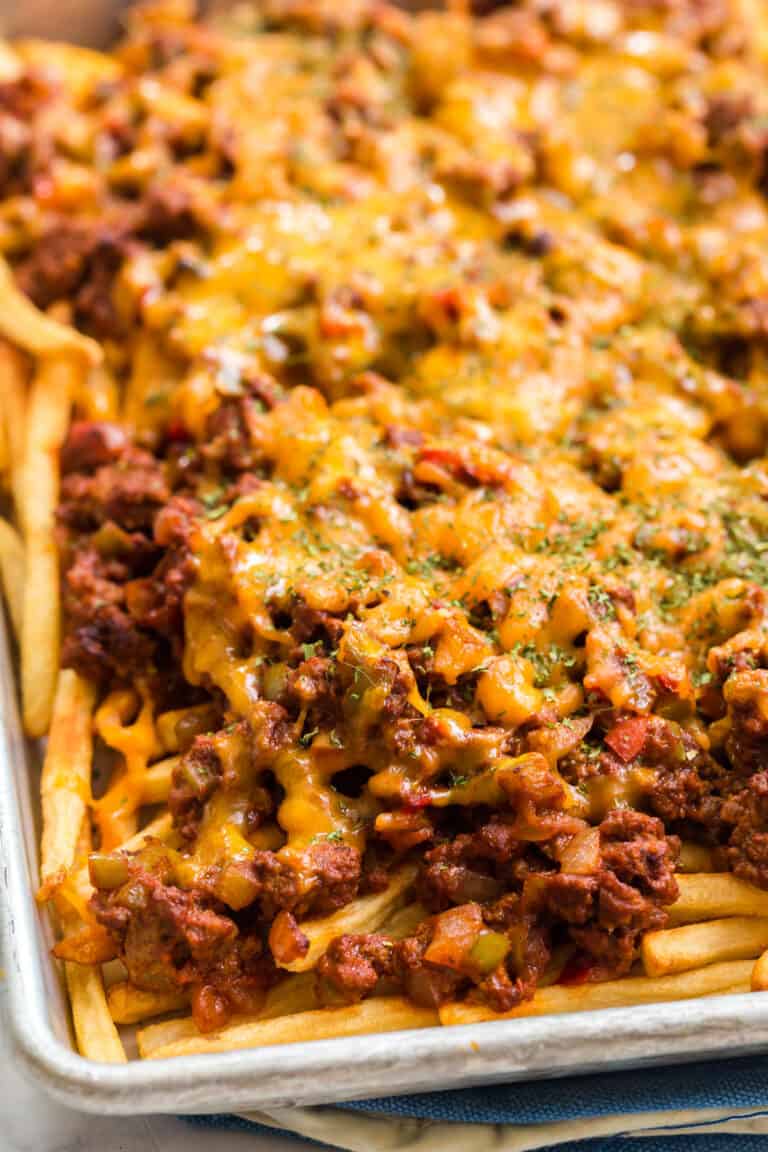 sloppy joe fries on a sheet pan with melted cheddar cheese