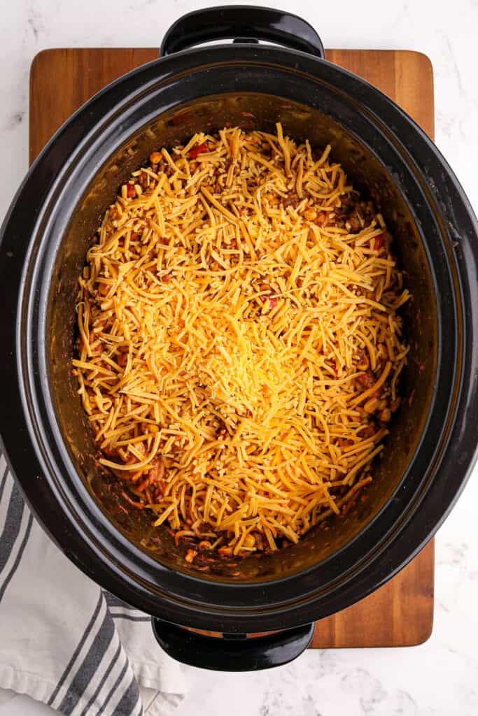 adding cheese to a slow cooker