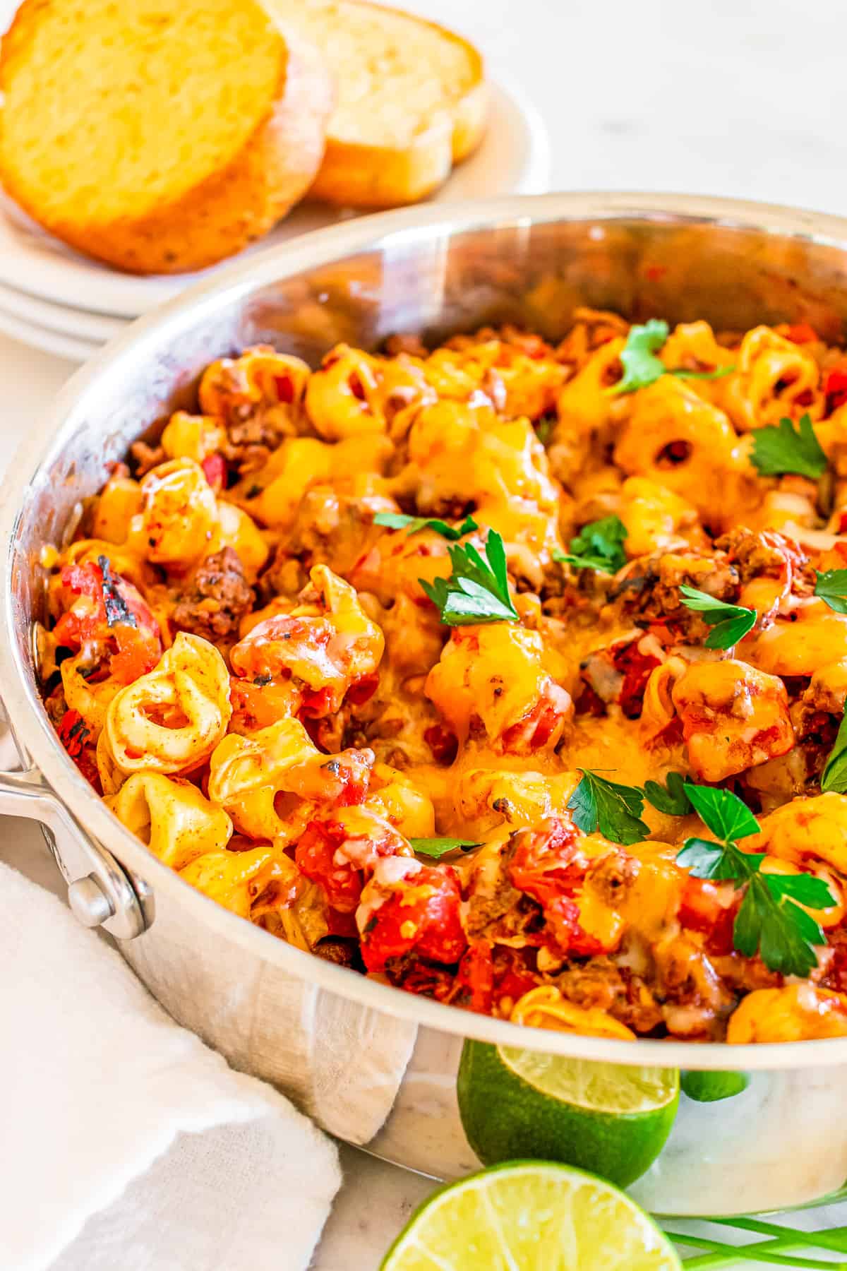 side angle of cheese tortellini in a skillet cooked with ground beef