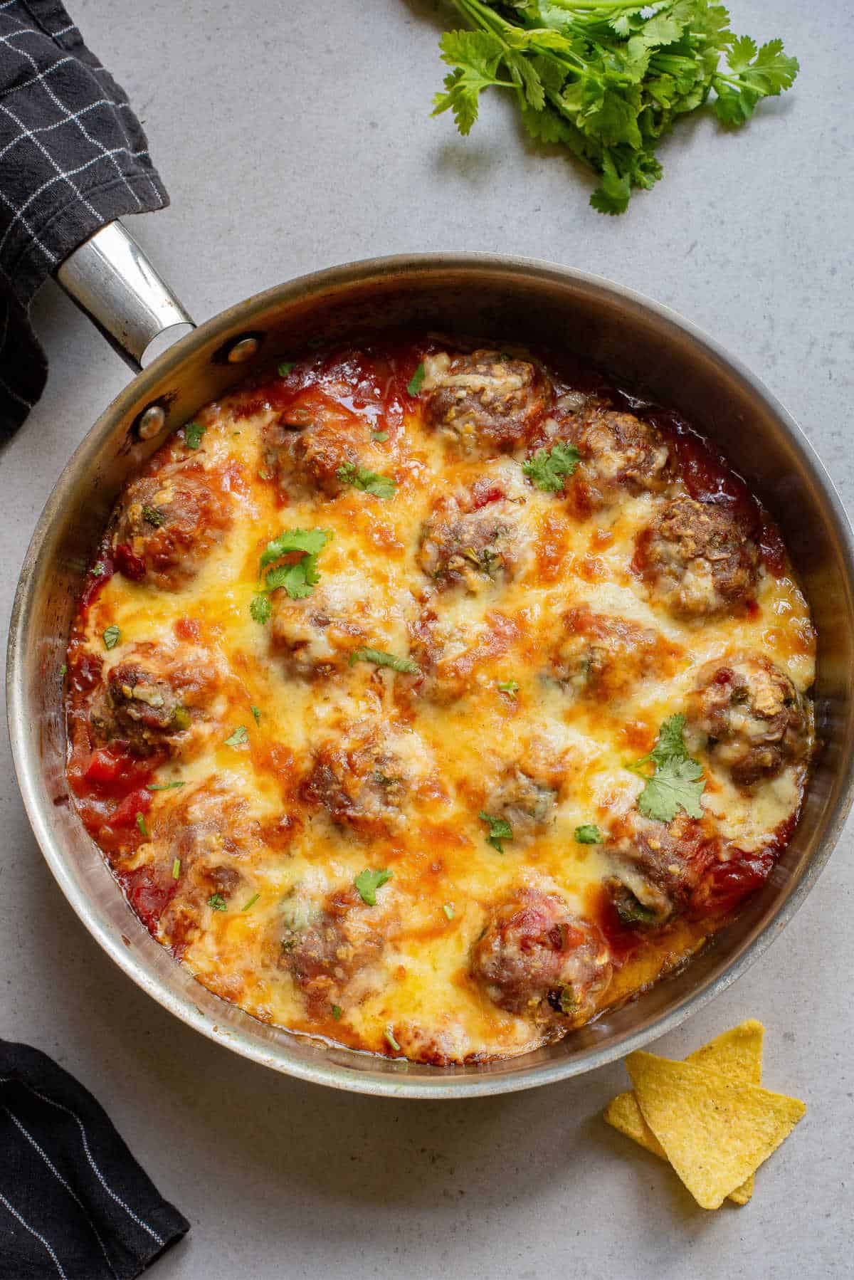 Baked Mexican Meatballs in a skillet.