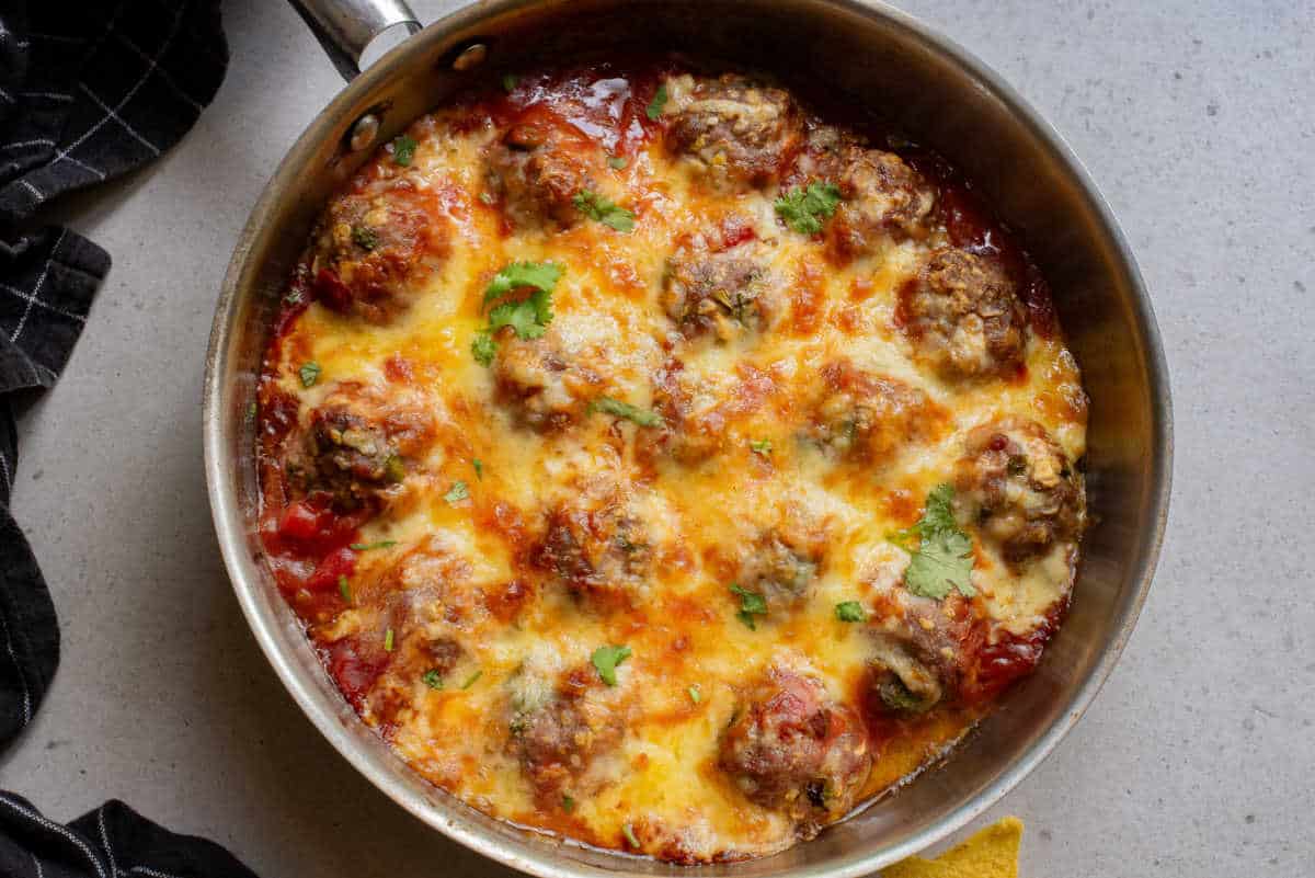 Baked Mexican Meatballs in a skillet.