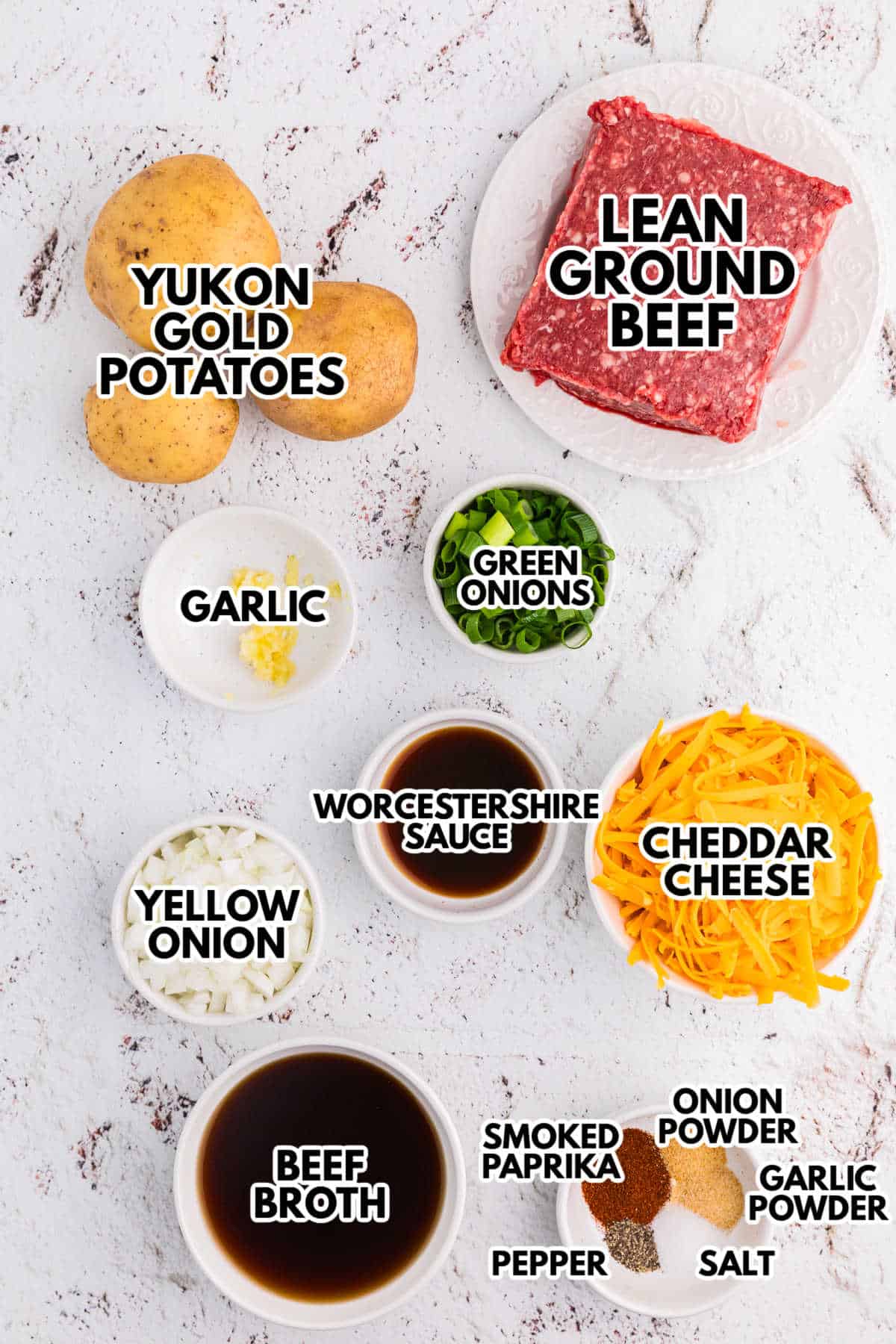 Ingredients for Cheesy Ground Beef and Potato Skillet, including Yukon Gold potatoes, lean ground beef, cheddar cheese, beef broth, onions, garlic, Worcestershire sauce, and seasonings.