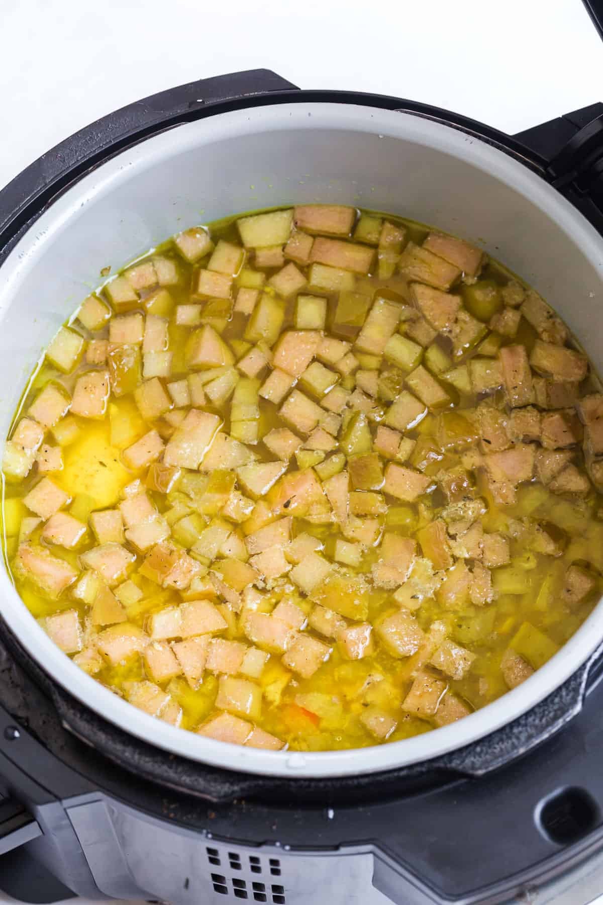 cooked apples with chicken, broth, and vegetables