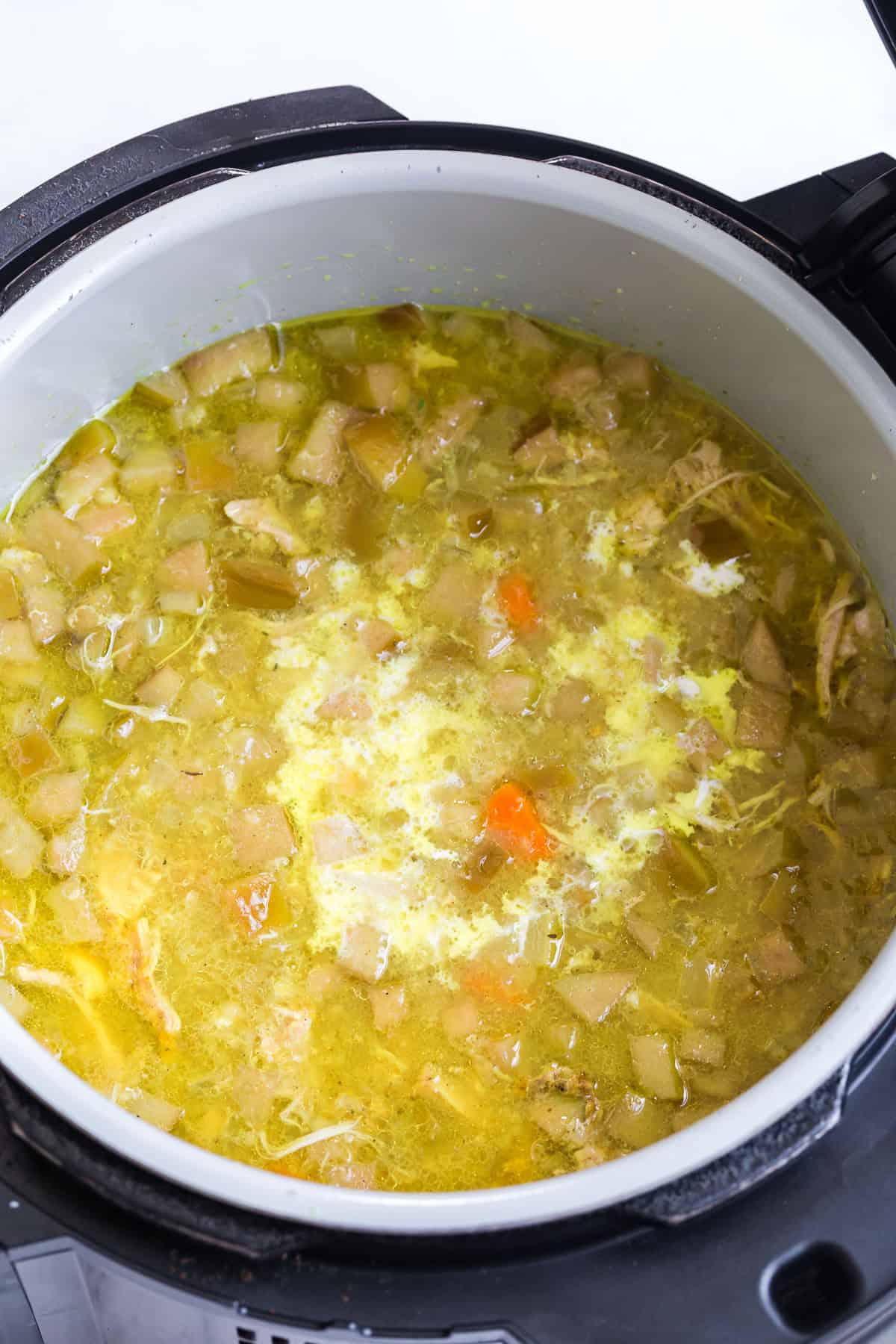 Adding cream to mulligatawny soup